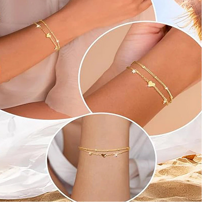 Two delicate 14k gold-plated bracelets with a heart pendant.