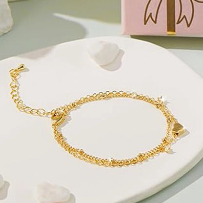 Two delicate 14k gold-plated bracelets with a heart pendant.