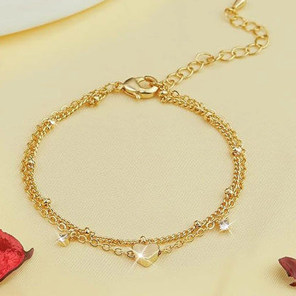 Two delicate 14k gold-plated bracelets with a heart pendant.